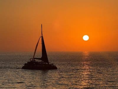 Puesta de sol desde el puerto de Cádiz con copa de cava