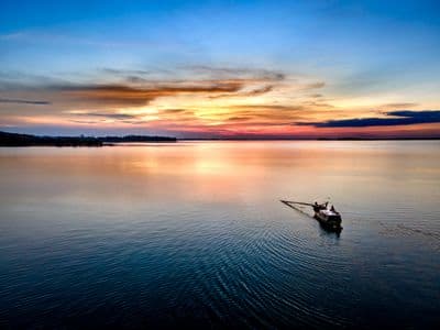 Silhouette of passenger on boat during sunset bay tour