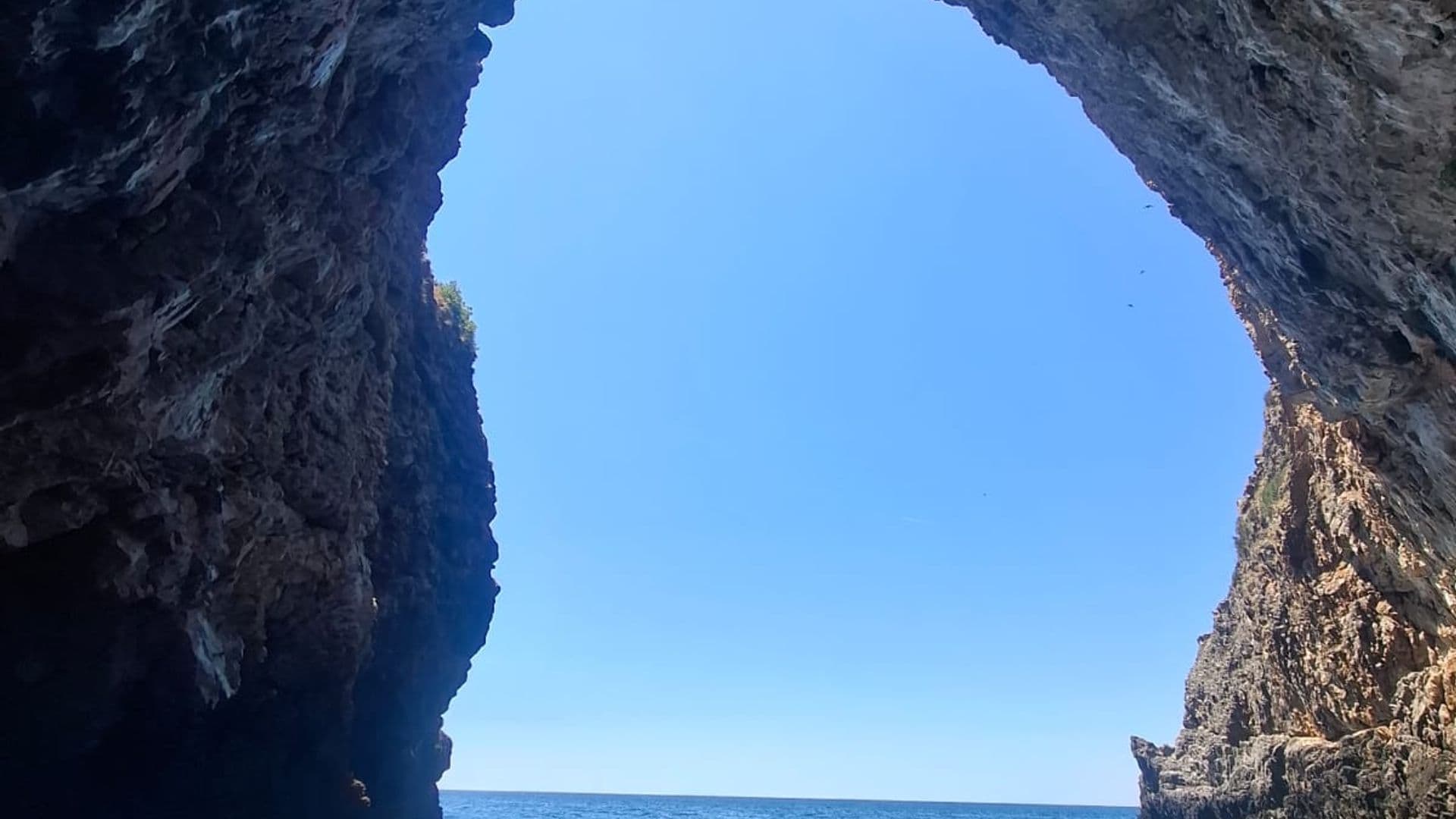 Natural sea cave arch on the Montenegrin coast seen from the boat