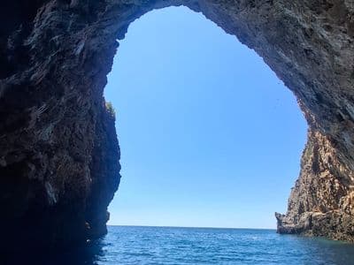 Natural sea cave arch on the Montenegrin coast seen from the boat