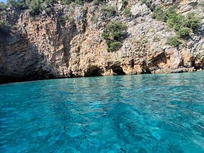 Turquoise water below coastal cliffs near Budva