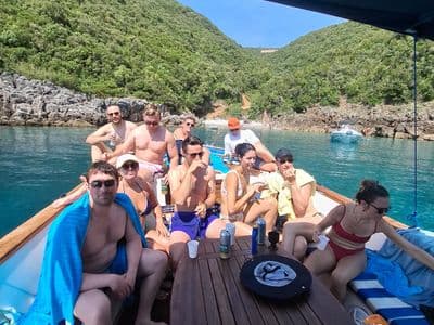 Guests relaxing under the canopy in a quiet cove near Budva