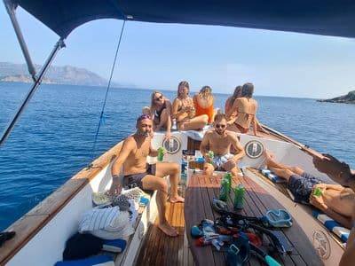 Guests on deck with snorkelling gear and drinks