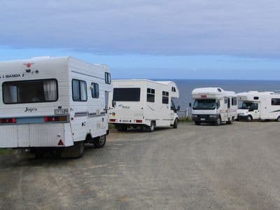 Campervans parked at Tautuku Bay, New Zealand