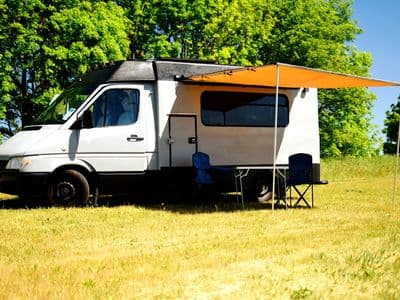 Unbranded Mercedes-Benz Sprinter campervan GI Joe with awning, camping table and chairs