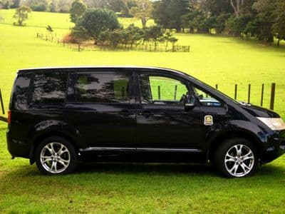 Side view of black Mitsubishi Delica sleeper van Black Hawk