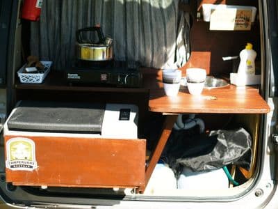 Rear kitchen of Serenity with fridge, stove and crockery