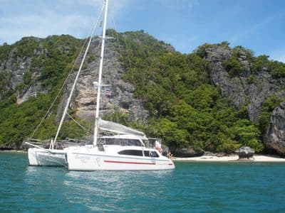 Dreamcatcher anchored in a green island bay in Ang Thong Marine Park