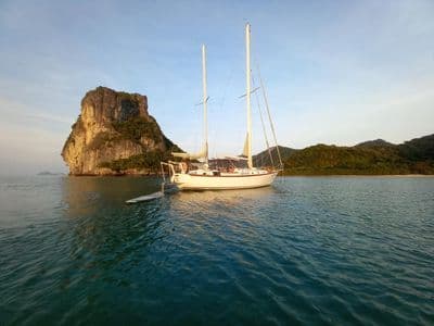 Geronimo anchored next to a rock island in calm water