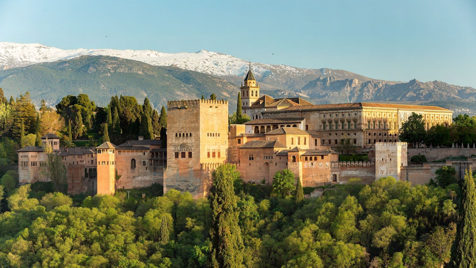 The Alhambra in Granada seen from the Mirador de San Nicolás, with the snow-covered Sierra Nevada behind