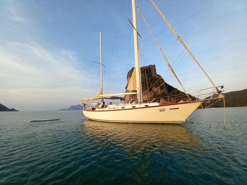 Classic sailing yacht at anchor in golden evening light off Koh Samui