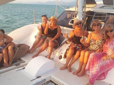 Guests relaxing on the catamaran deck during a half-day cruise