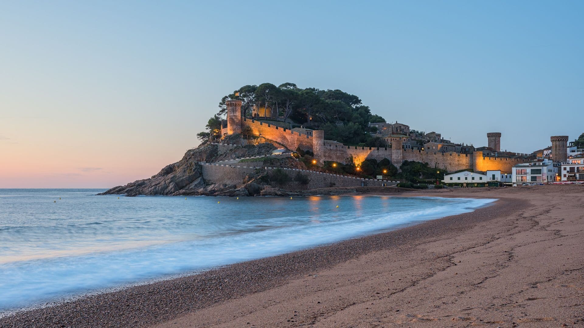 Walled old town of Tossa de Mar above the beach at dusk, Costa Brava, a campervan trip north of Barcelona