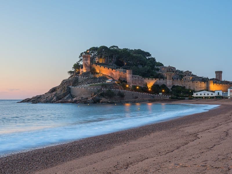 Walled old town of Tossa de Mar above the beach at dusk, Costa Brava, a campervan trip north of Barcelona