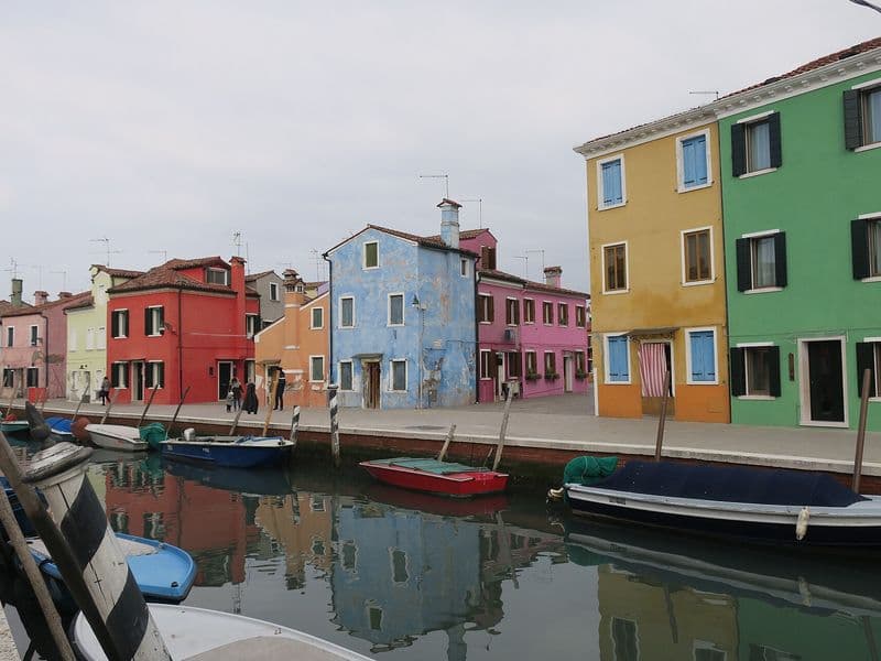 Kanal s brodicama i šarenim kućama na otoku Burano u Venecijanskoj laguni
