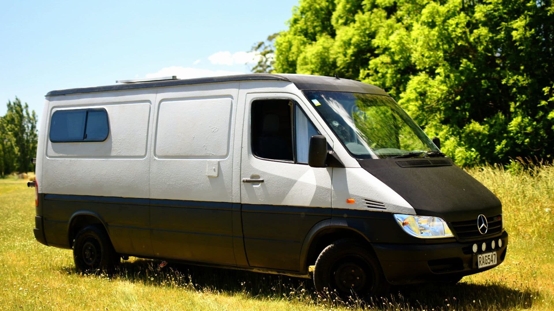 Unbranded Mercedes-Benz Sprinter campervan The A Van parked on grass