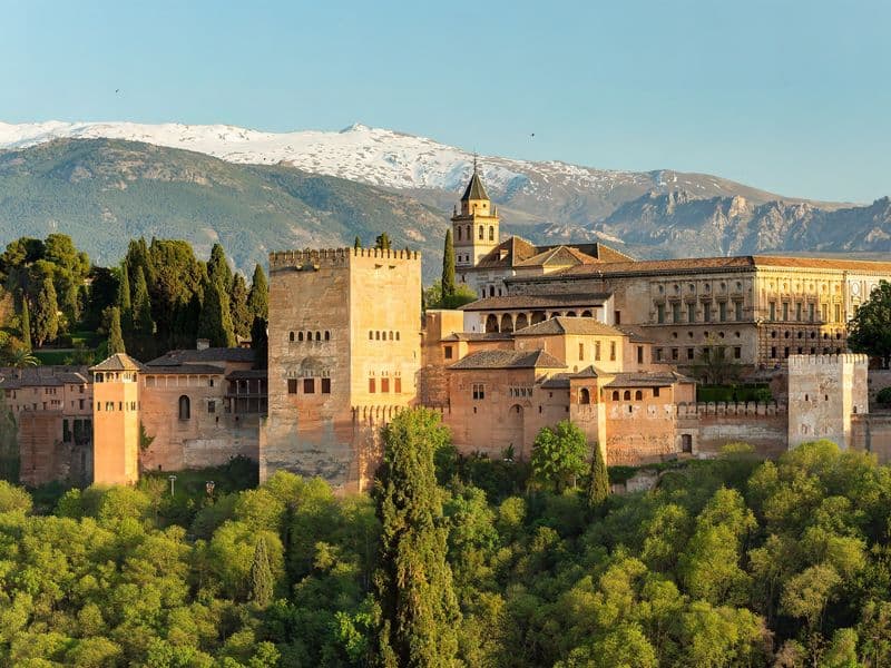 The Alhambra in Granada seen from the Mirador de San Nicolás, with the snow-covered Sierra Nevada behind