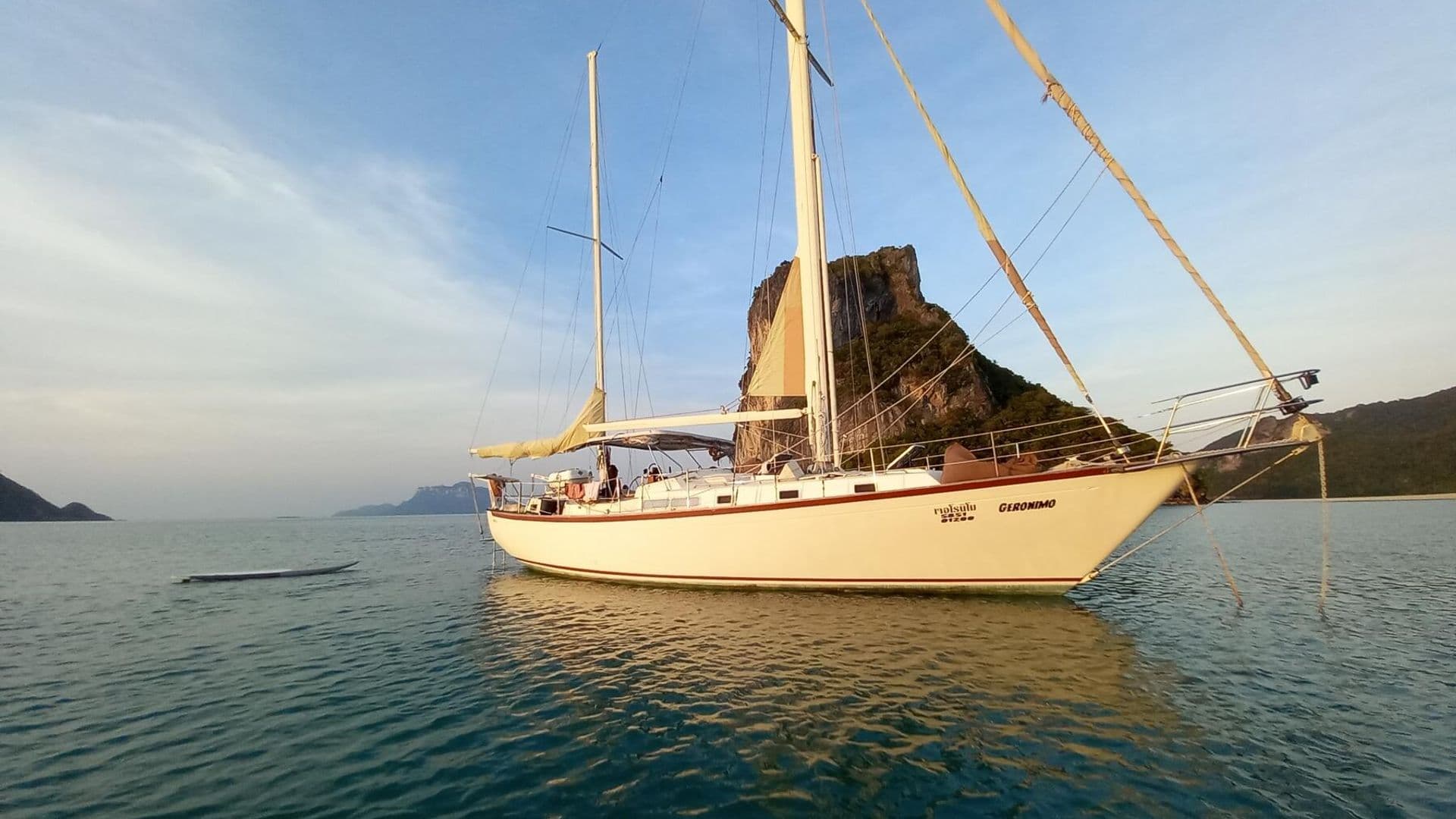 Classic sailing yacht at anchor in golden evening light off Koh Samui